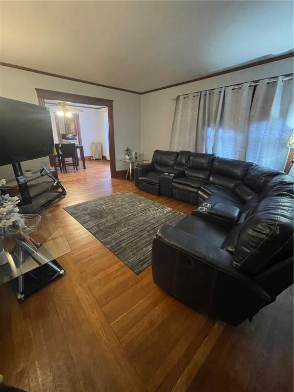 51 Oakland Ave, Cranston, RI 02910 - living area featuring radiator heating unit and wood finished floors