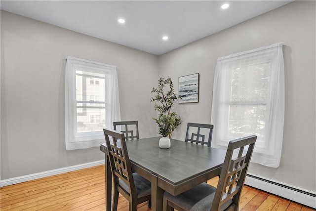 dining space featuring baseboard heating, recessed lighting, baseboards, and light wood-style floors