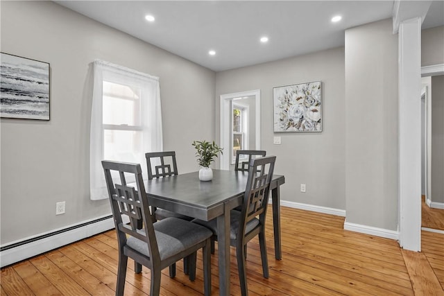 dining room with recessed lighting, light wood-style flooring, baseboards, and a baseboard radiator