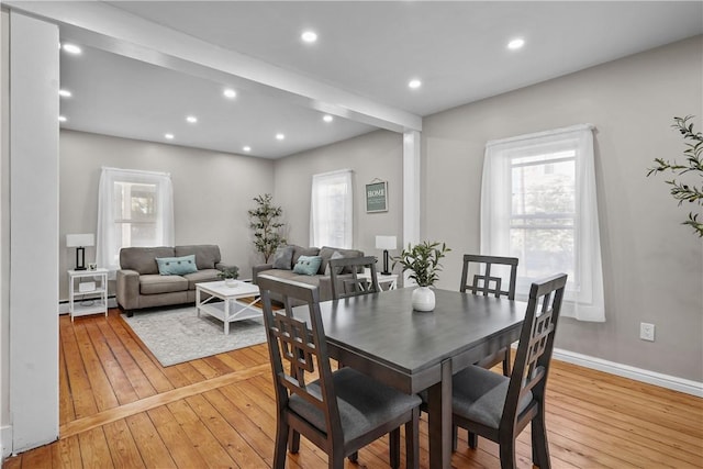 dining space with recessed lighting, baseboard heating, and light wood-style flooring