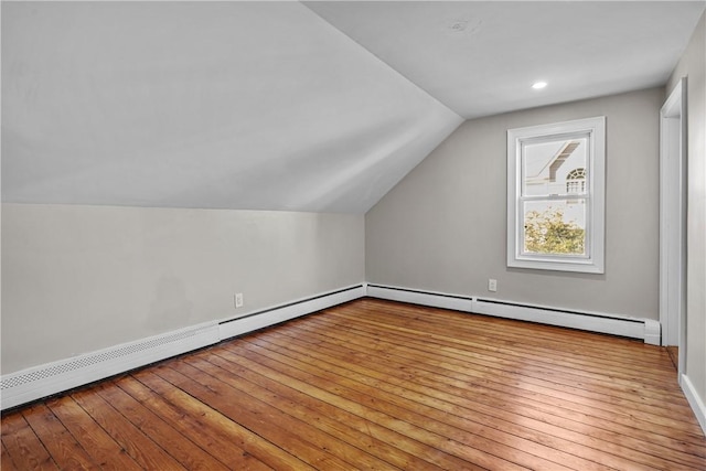 bonus room with vaulted ceiling, a baseboard radiator, and hardwood / wood-style flooring