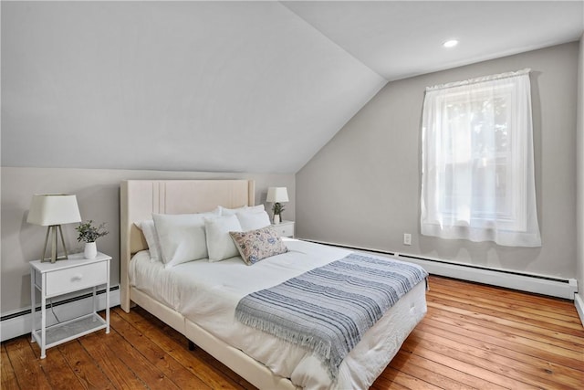 bedroom featuring vaulted ceiling, a baseboard heating unit, and hardwood / wood-style floors