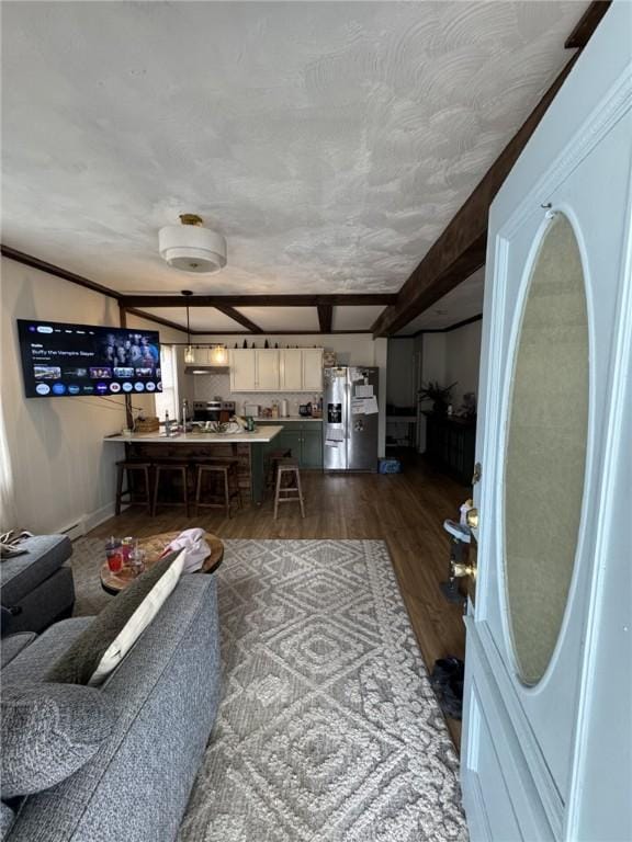 living room with dark wood-type flooring and beamed ceiling