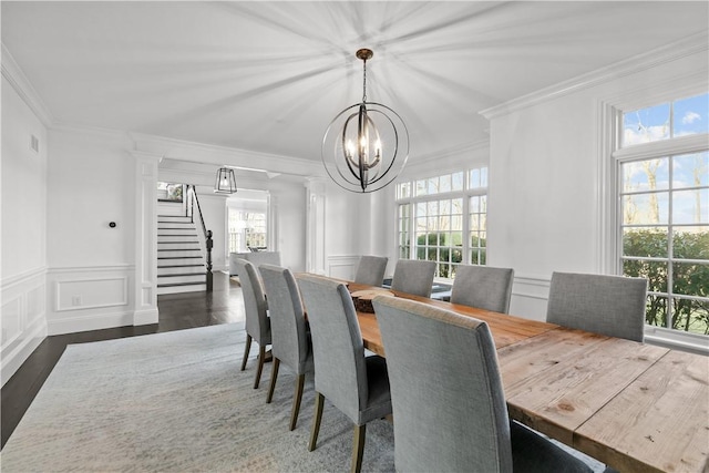 50 Kenyon Ave, East Greenwich, RI 02818 - dining space with a decorative wall, crown molding, a chandelier, and stairs