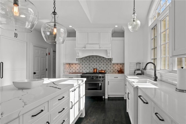 50 Kenyon Ave, East Greenwich, RI 02818 - kitchen featuring range with gas stovetop, white cabinets, decorative backsplash, and a sink