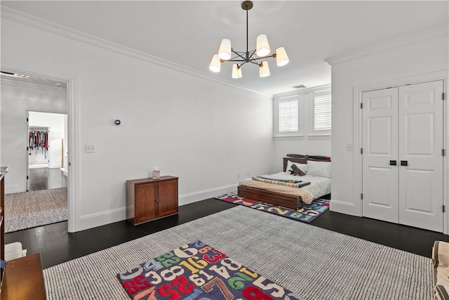 50 Kenyon Ave, East Greenwich, RI 02818 - bedroom featuring a closet, crown molding, baseboards, dark wood finished floors, and an inviting chandelier