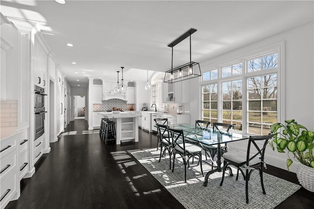 50 Kenyon Ave, East Greenwich, RI 02818 - dining room featuring baseboards, recessed lighting, dark wood-type flooring, and an inviting chandelier