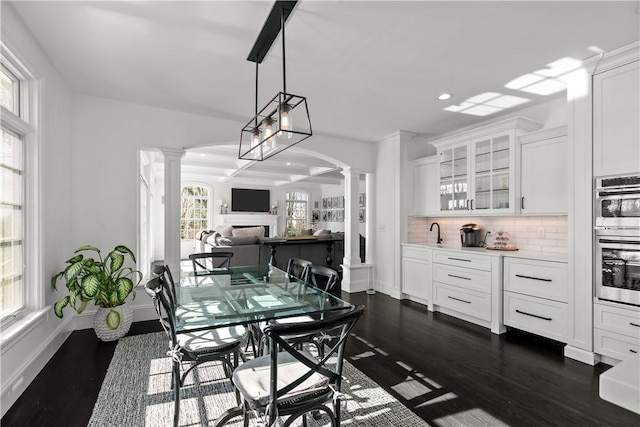 50 Kenyon Ave, East Greenwich, RI 02818 - dining room featuring decorative columns, recessed lighting, baseboards, and dark wood finished floors