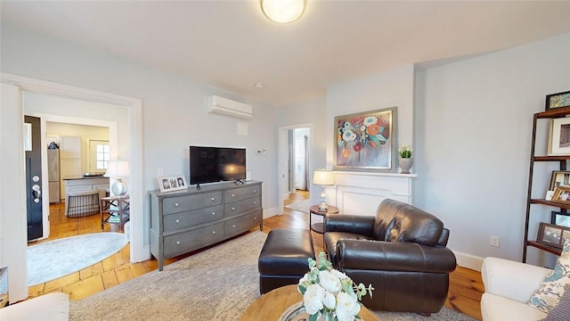 living room with baseboards, wood finished floors, and a wall mounted AC