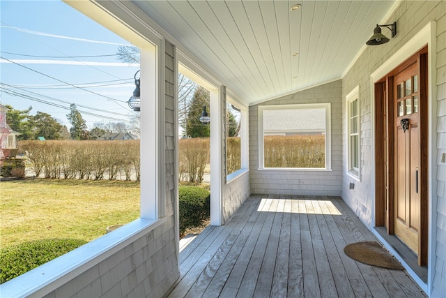 unfurnished sunroom featuring vaulted ceiling and wooden ceiling