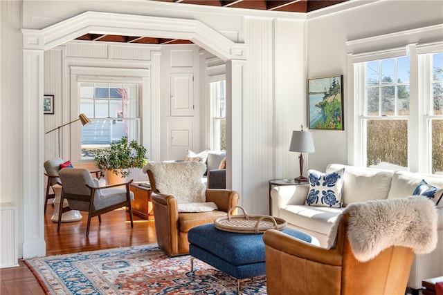 sitting room featuring wood finished floors and a healthy amount of sunlight