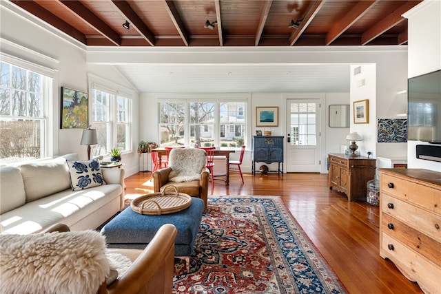 living room with hardwood / wood-style flooring, lofted ceiling with beams, wooden ceiling, and track lighting