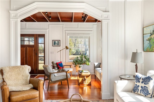 sitting room with wood ceiling and wood finished floors