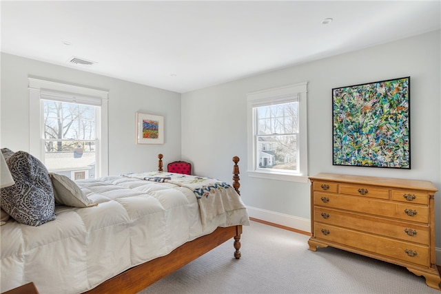 bedroom with visible vents, multiple windows, and baseboards