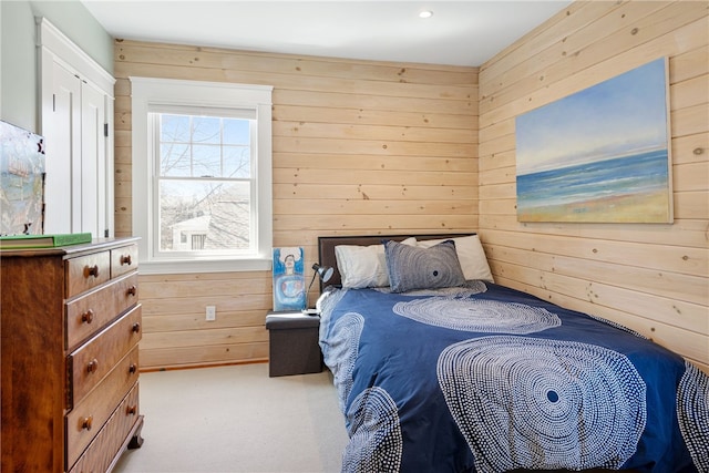 bedroom featuring carpet flooring and wooden walls