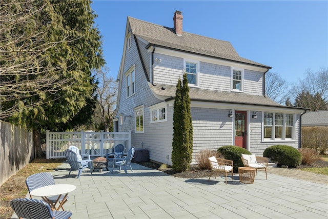 exterior space with an outdoor fire pit and fence