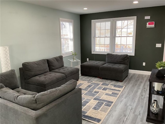 living area with light wood-style flooring, recessed lighting, and baseboards