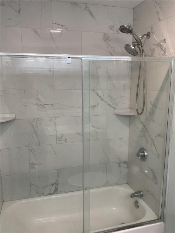 full bathroom with shower / bath combination with glass door