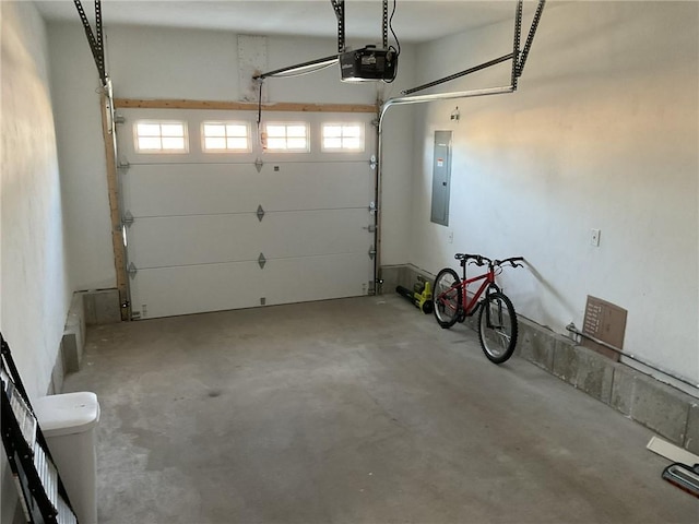 garage featuring electric panel and a garage door opener