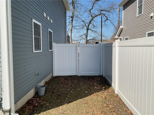 view of side of home featuring fence