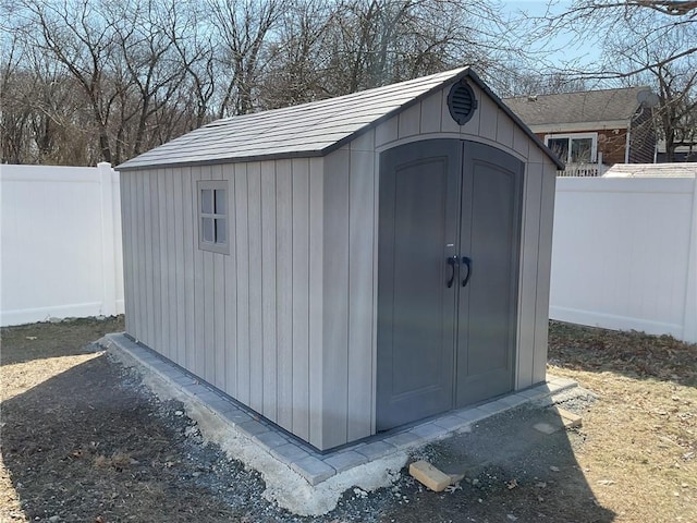 view of shed with a fenced backyard