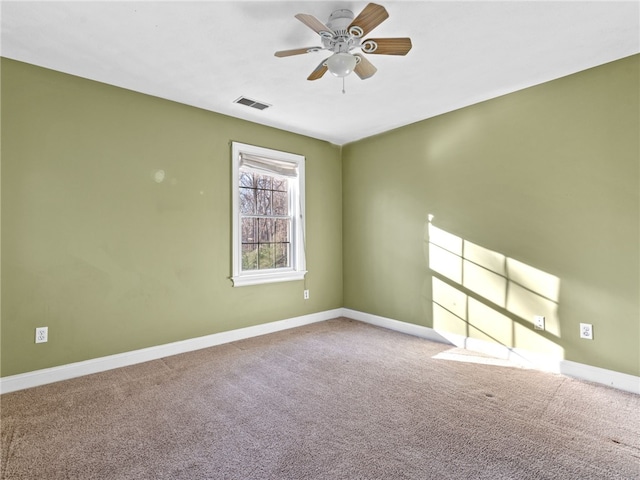 unfurnished room with baseboards, carpet, and a ceiling fan