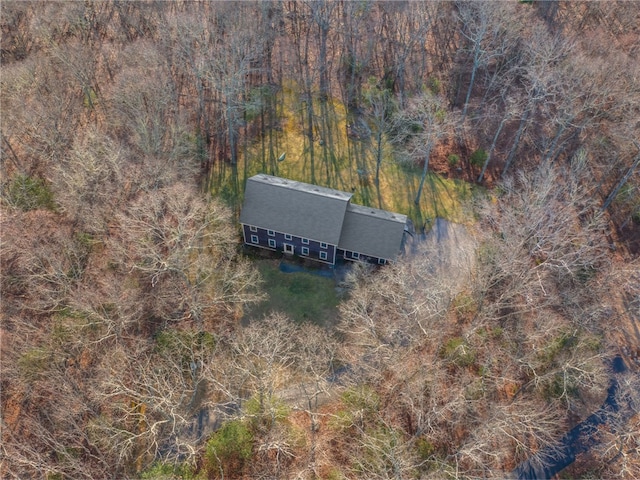 drone / aerial view with a wooded view