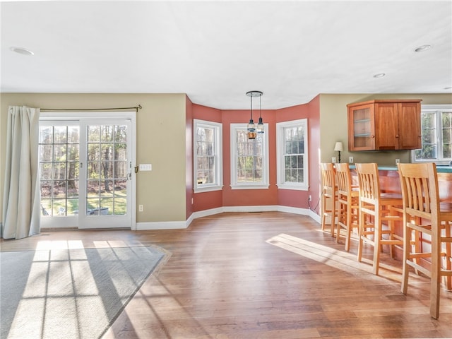 dining space with recessed lighting, baseboards, and light wood finished floors