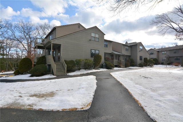 view of snow covered exterior with a residential view