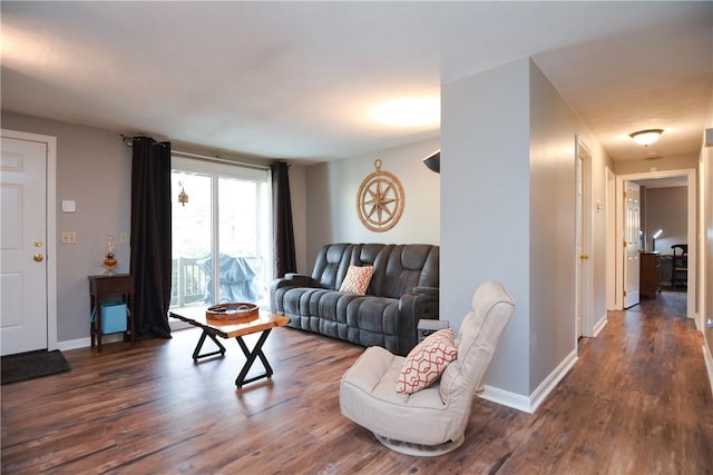 living area featuring baseboards and wood finished floors