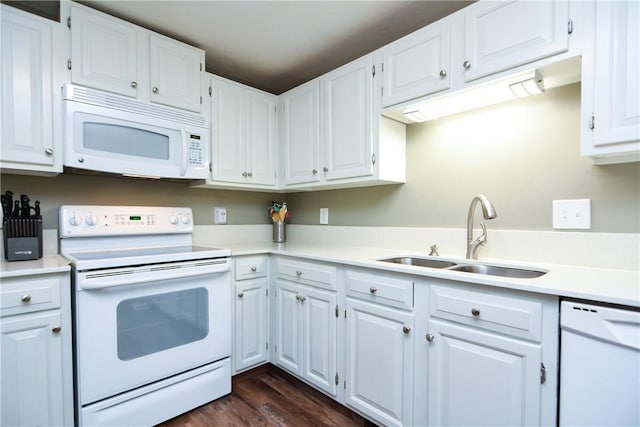 kitchen featuring a sink, white appliances, white cabinetry, and light countertops