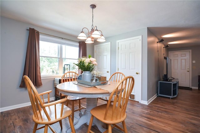 dining space with wood finished floors, baseboards, and a chandelier