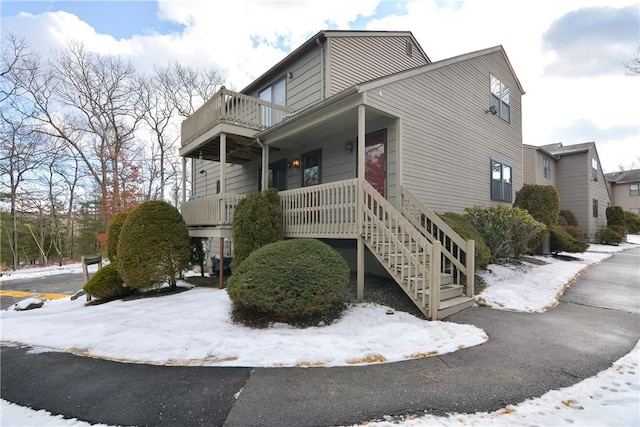 view of front facade with a balcony and a porch