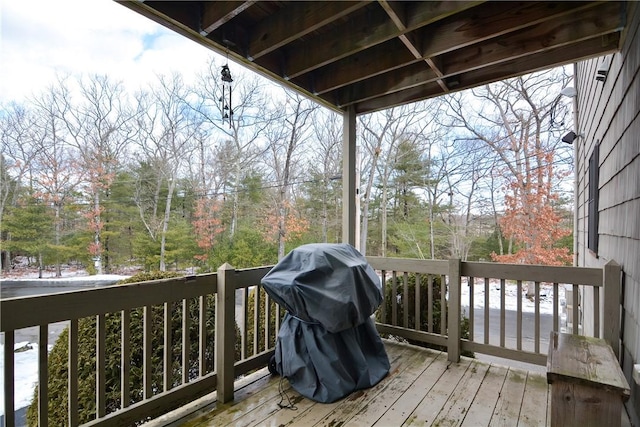 wooden terrace featuring a grill