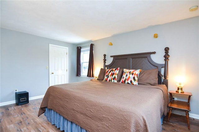 bedroom with baseboards and light wood-style flooring