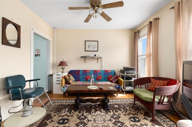 living room featuring wood finished floors and ceiling fan