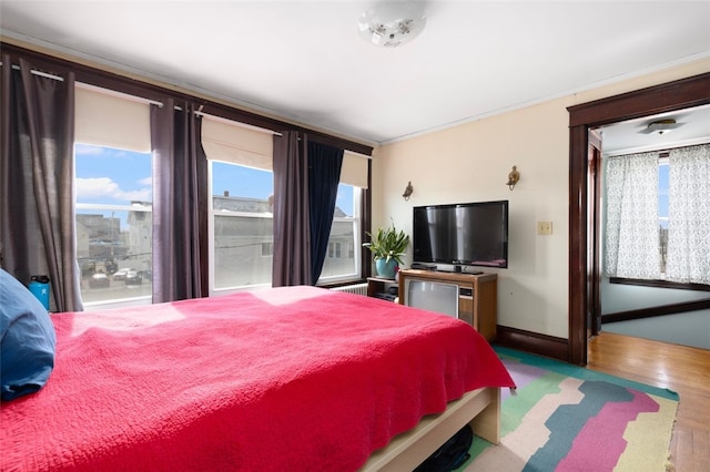 bedroom featuring baseboards and wood finished floors