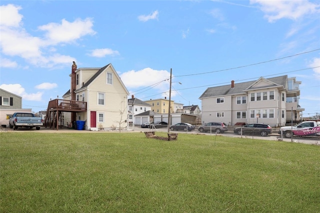 view of yard with stairway, a deck, and fence