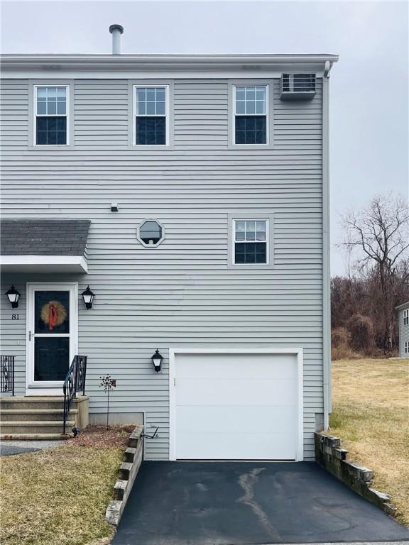 view of front of property with aphalt driveway and an attached garage