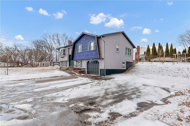 snow covered property featuring a chimney