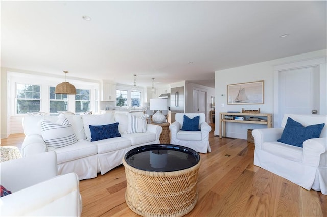 living area featuring recessed lighting and light wood-style floors