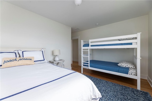 bedroom featuring baseboards and wood finished floors