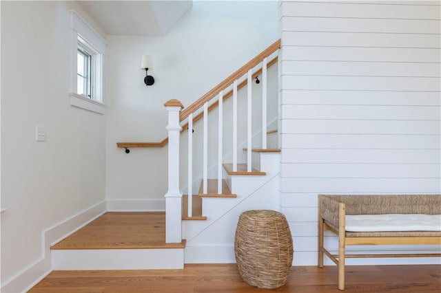 stairs featuring baseboards and wood finished floors