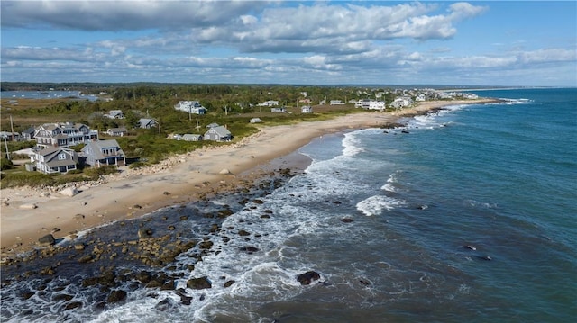 drone / aerial view featuring a beach view and a water view