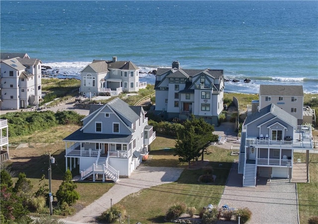 birds eye view of property with a water view and a residential view