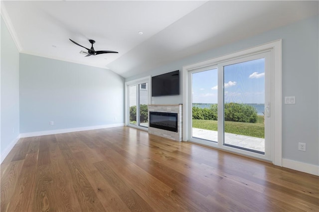 unfurnished living room featuring baseboards, wood finished floors, a ceiling fan, and vaulted ceiling