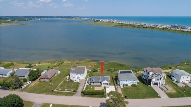 drone / aerial view with a water view and a residential view