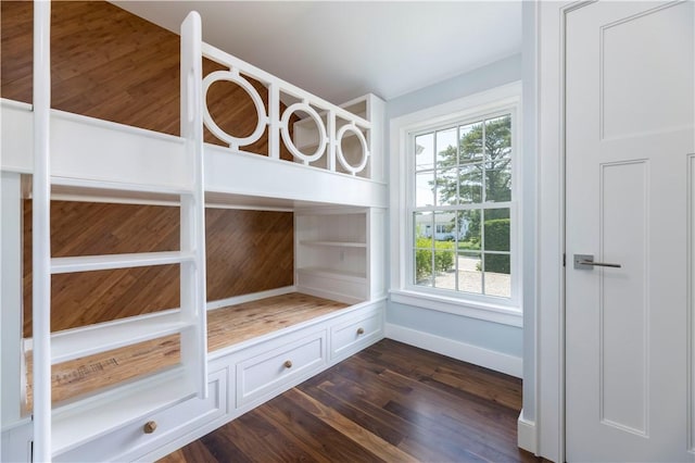 unfurnished bedroom featuring dark wood-style floors and baseboards