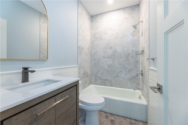 full bath with shower / tub combination, wainscoting, toilet, and vanity