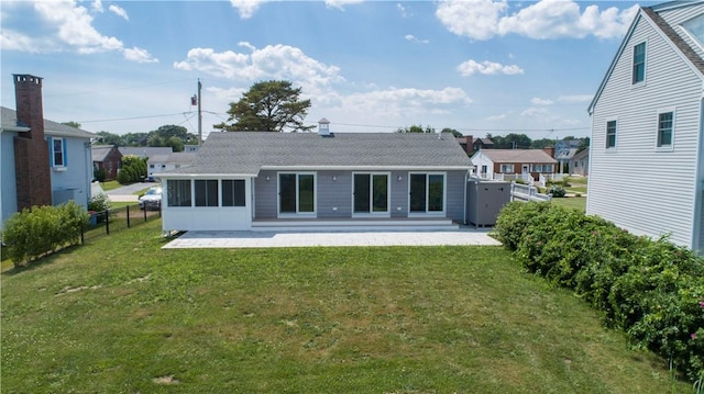 rear view of house with a patio area, a yard, and fence